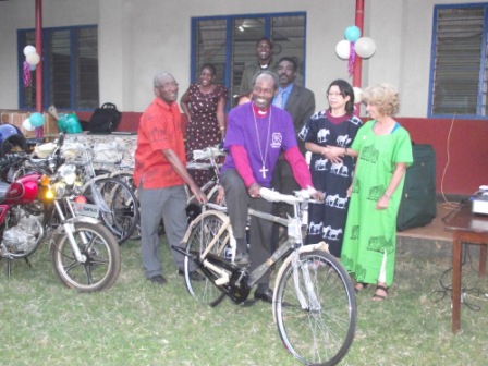 Bishop Mwita on a test ride of donated bicycle