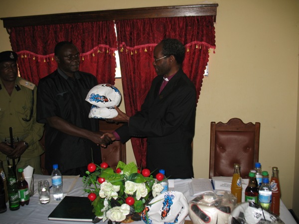 Bishop Mwita handing soccer balls to the Regional Police Commander on August 8, 2012
